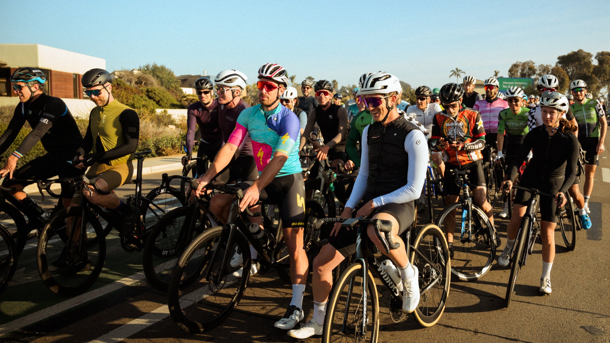 Professional cyclist Peter Sagan leading Group of cyclists riding bicycles on a road with clear skies in Encinitas California.