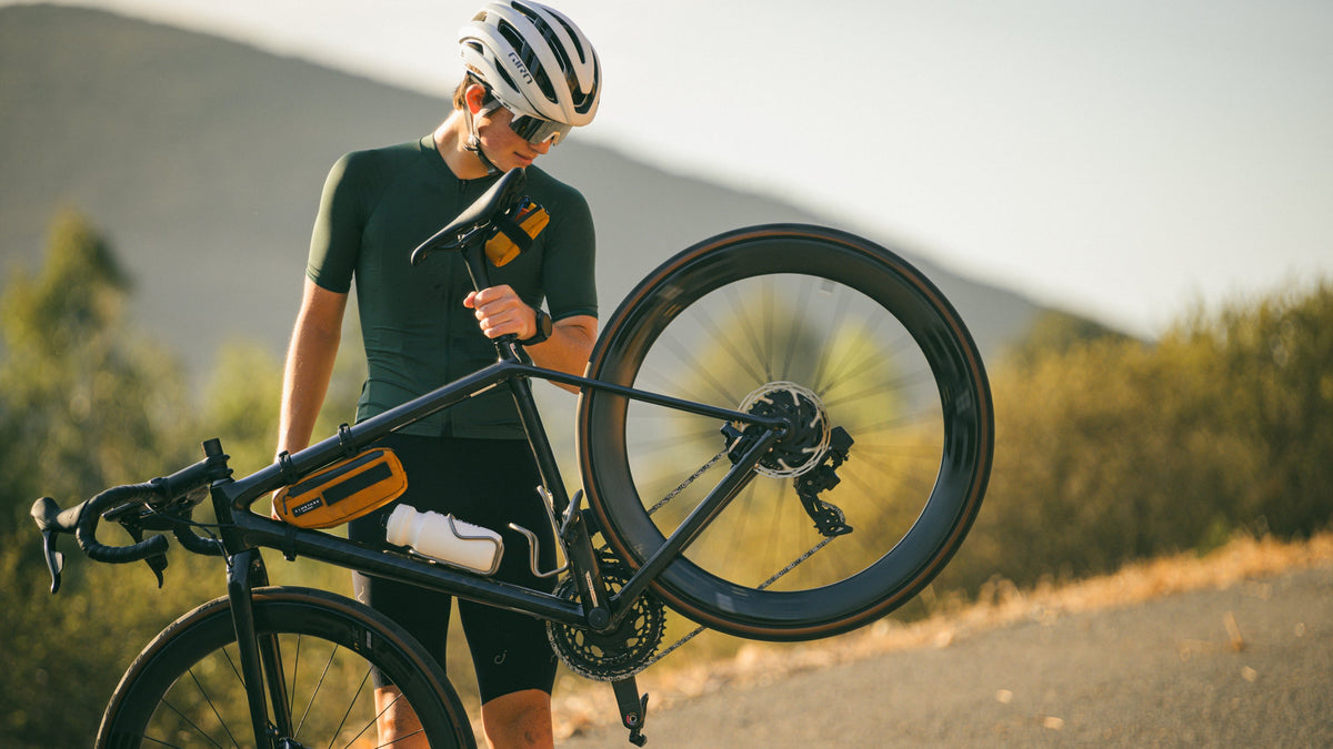 Person with a bicycle on a mountain road